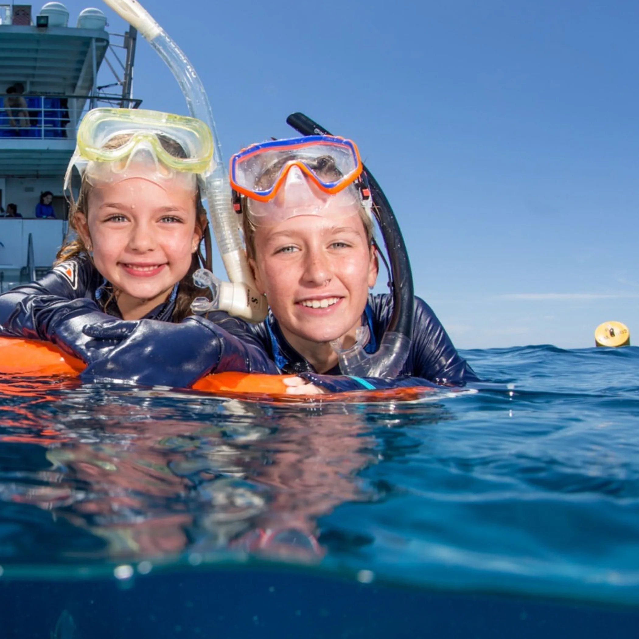 family snorkeling on great barrier reef